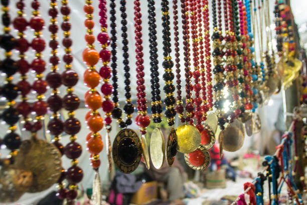 Multicolored jewelry hanging in a shop in Poush Mela handicrafts fair.